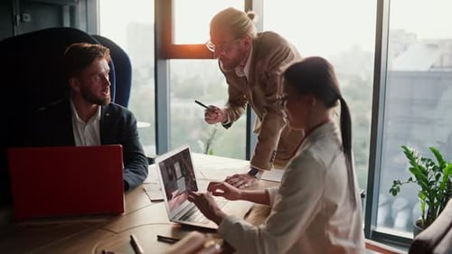 Team Discussing Business at Bright Office Table