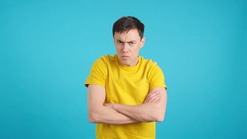 Man Annoyed with Arms Crossed Looking Serious