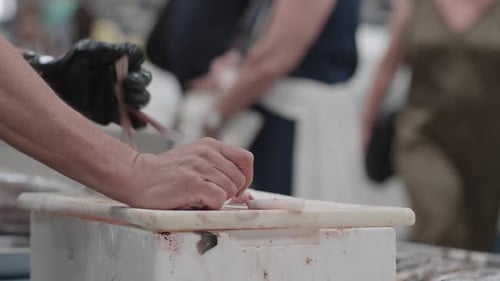 Zubereitung von frischem Fisch auf dem geschäftigen Markt während der Morgenstunden in einer Küstenstadt