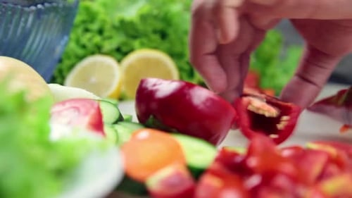 Hands Chopping Red Bell Pepper for Salad