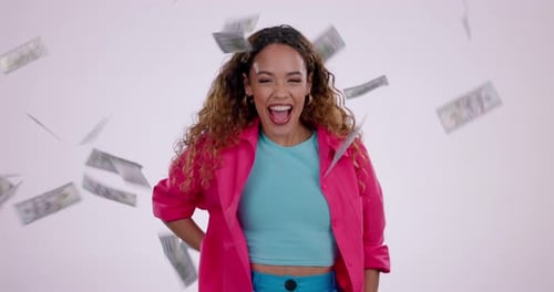 Happy woman, money rain and dancing in celebration, winning or financial freedom against a studio