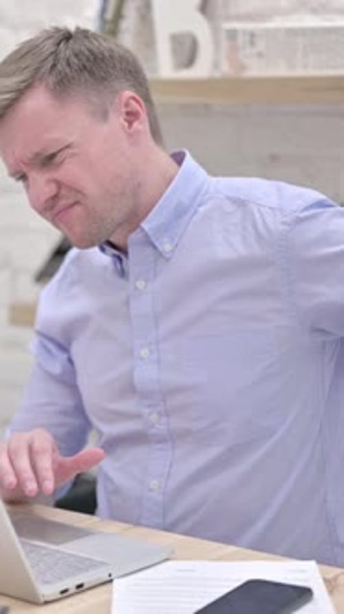 Adult Man Experiencing Back Pain While Using Laptop