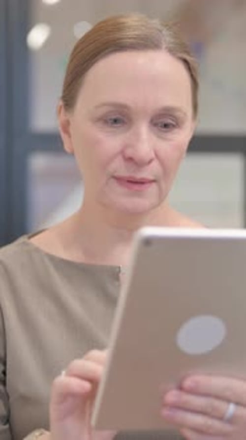 Enthusiastic Woman Celebrating Success on Tablet Device