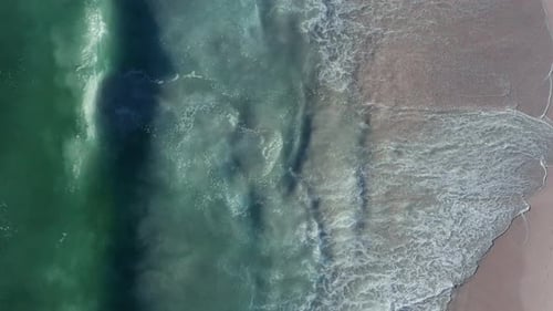 Vertical Shot Of Blouberg Sea With Foamy Waves Splashing On The Coastline At Cape Town In South Afri