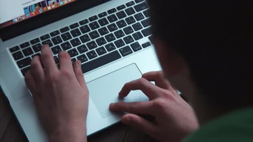 Hands Typing on Laptop Keypad
