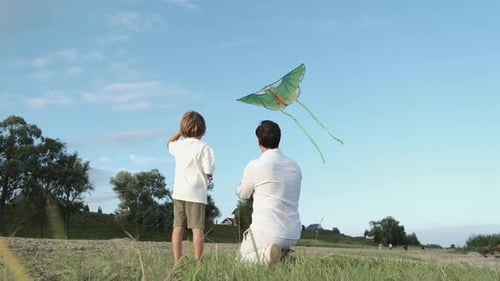 Child and Adult Flying Kite in Rural Setting