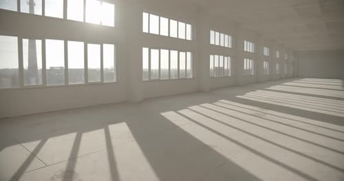 Bright Empty Industrial Room with Sunlight Streaming In
