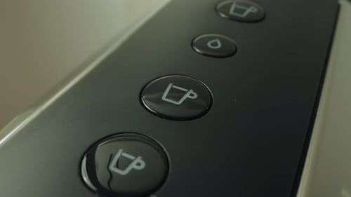 Finger Pushing Button on Coffee Machine Close Up