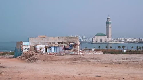 Ruined house and Hassan II mosque by the sea in Casablanca Morocco