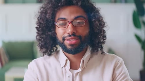 Young Adult Talking and Waving Indoors