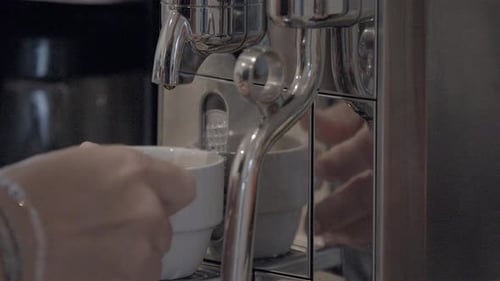 Coffee Being Dispensed from Chrome Coffee Machine
