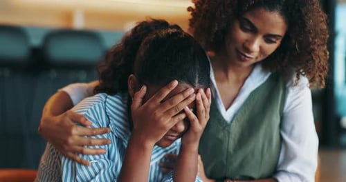 Woman Comforts Young Person Indoors