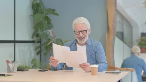 Senior Man Celebrates Reading Good News