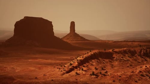 Aerial View of a Majestic Rock Formation Standing Tall in the Middle of a Desert