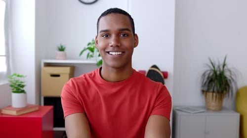 Close Up Portrait of Young Joyful African American Man Smiling at Camera at Home