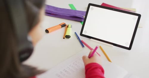 Child Studies with Tablet and Headphones