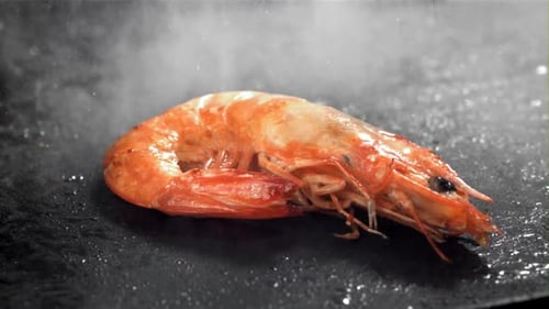 The Shrimp is Fried in a Pan with a Splash Filmed on a Highspeed Camera at 1000 Fps