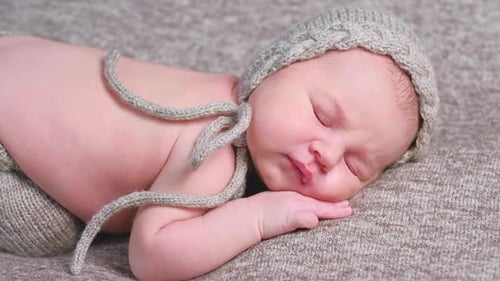 Sleeping Newborn Baby Wearing a Knit Hat