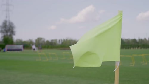 Green Corner Flag Blowing on Sports Field