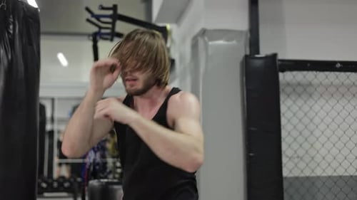 Brutal Male Training Alone in Empty Gym and Practicing Punches Before Fight