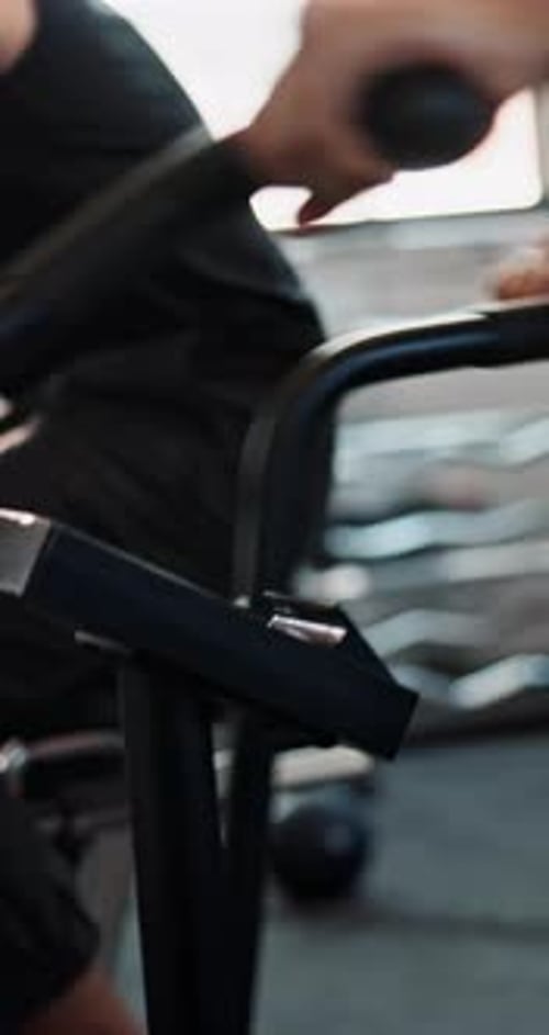 Exercise bike, cardio and men in gym, training and challenge with motivation, sweating and fitness