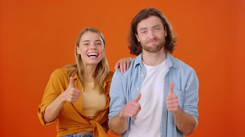 Cheerful Young Adults Giving Thumbs Up Together