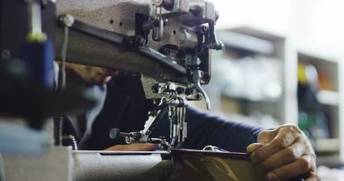 A YOUNG hand of an Italian tailor sew or cut your fabric to make a suit tailored in slow motion