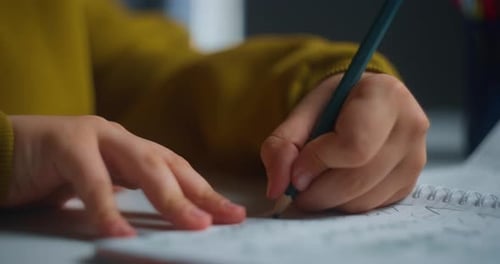 Closeup Of Hands Writing In Notebook Young Learner Engaged In Handwriting Exercises Under Warm