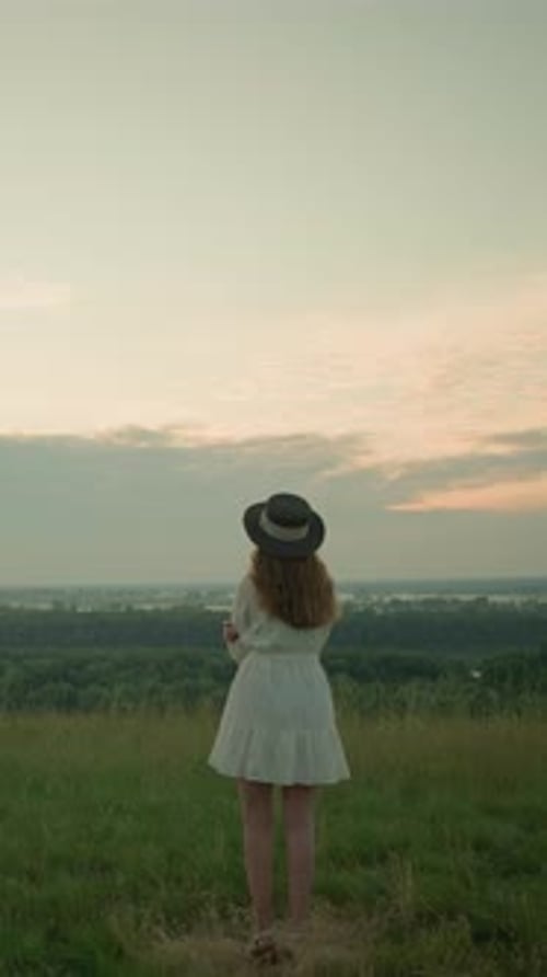 Woman in White Dress Reflecting By Lake at Sunset