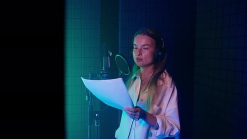 Female Voice Actor Recording Offcamera Text in Audio Studio