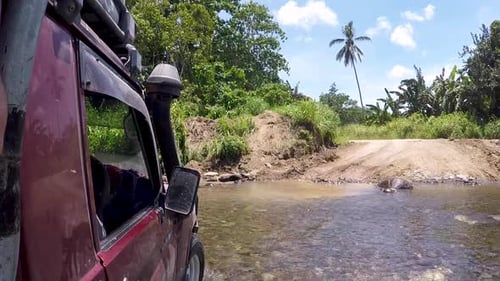 Four-wheel drive 4wd truck crossing a river in extreme off-road adventure in wilderness on remote tr