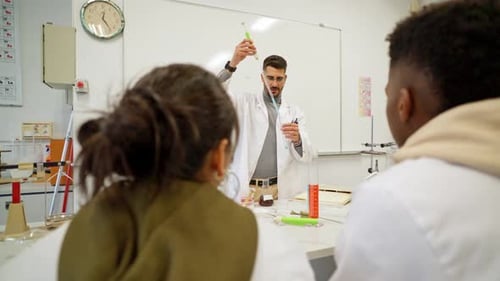 Instructor Demonstrates Science Experiment to Students in Lab
