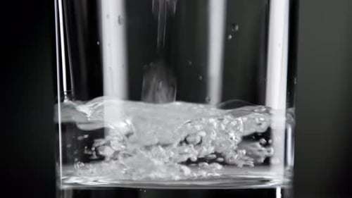 Drinking Fresh Water Falling Down Into Clear Glass Cup for Healthy Lifestyle