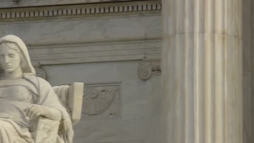 Contemplative statue stands guard before the United States supreme court building