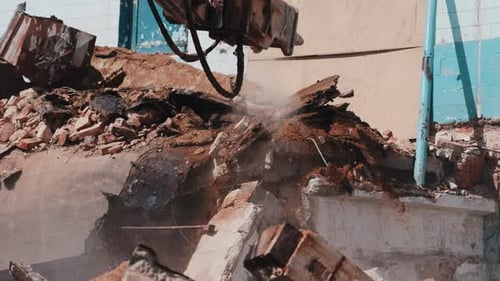 Excavator Breaking Concrete with Hydraulic Hammer During Demolition Close Up