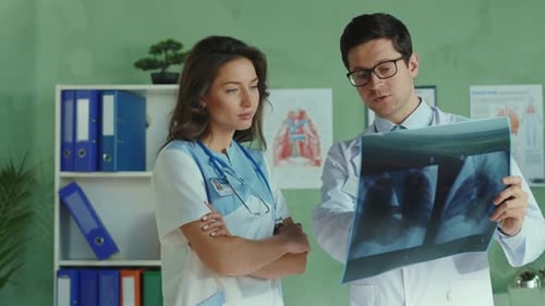 Team of Medical Workers Cooperating in the Private Clinic Office Doctor and Nurse Discussing Therapy