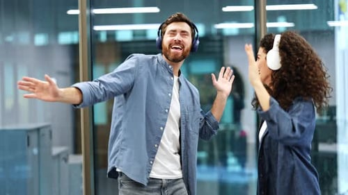 Business Colleagues Dancing and Listening to Music in Office