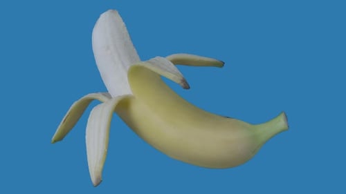 Rotating Peeled Banana on Blue Background