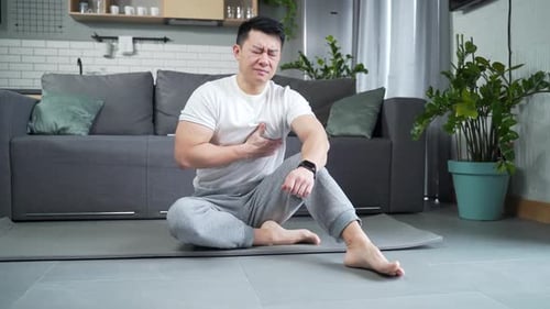 Man Experiencing Chest Pain Checks Pulse on Watch