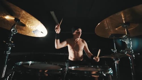 Rock Band Drummer Playing Drums During Concert