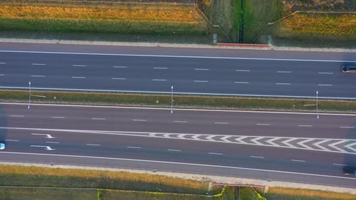Aerial top view of highway road. Drone view of the elevated road, traffic junctions, and green garde