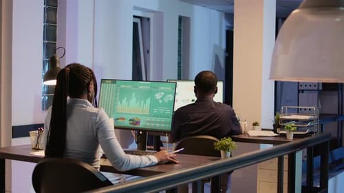 Company Employee Analyzing Business Report Charts on Computer