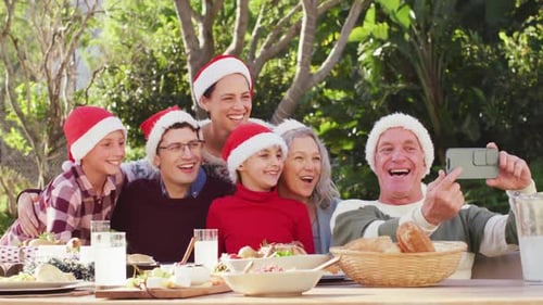 Happy caucasian family having christmas dinner in garden