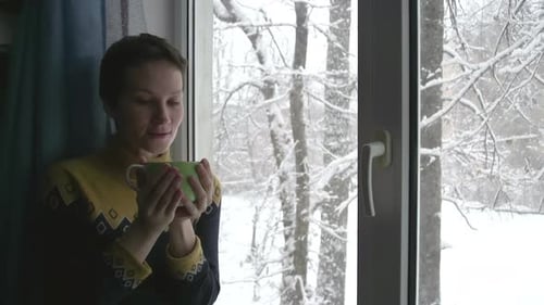 Snow Outside The Window And Hot Tea