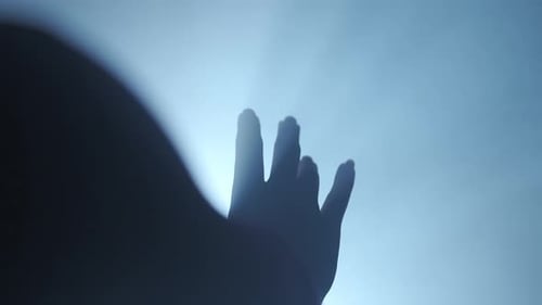 Abstract Hand Reaching for Bright Light in Darkness