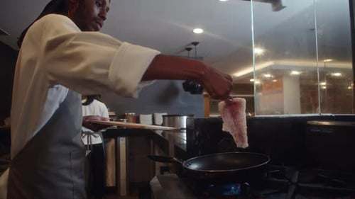 Head Chef Frying Fish Fillet at Restaurant Kitchen