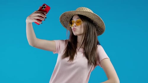 Woman Posing With Phone Against Blue Background