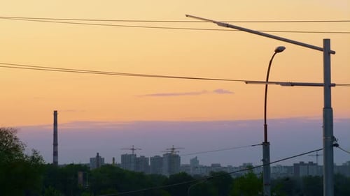 Street Lanterns with Electric Wires at Warm Evening Cityscape View Drone