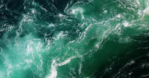 Blue waves of water of the river and the sea meet each other during high tide and low tide.