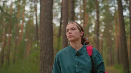 Young Woman Hiking Through Peaceful Forest Trail with Friend